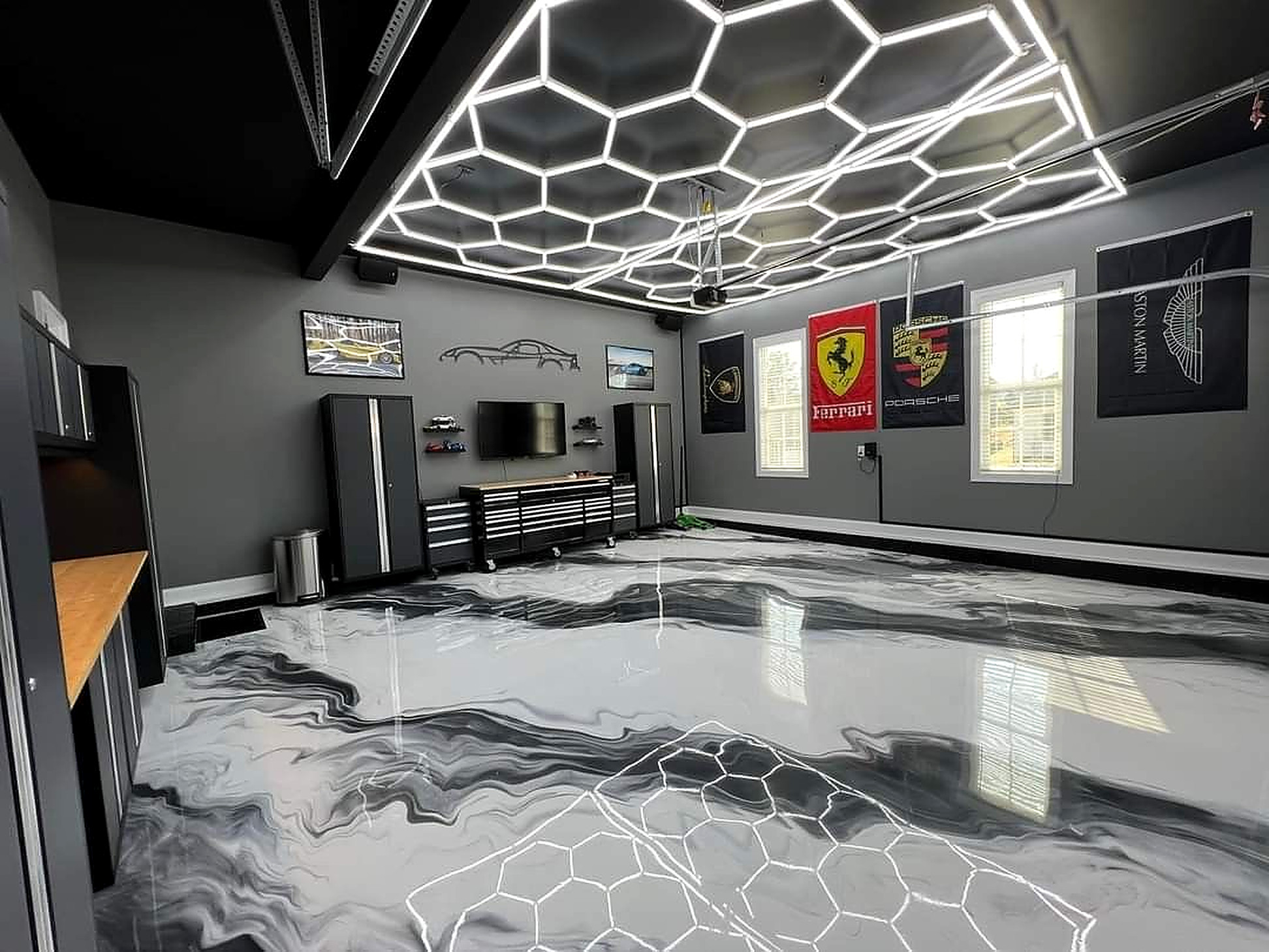 Garage with LED hex accent lighting over a metallic floor