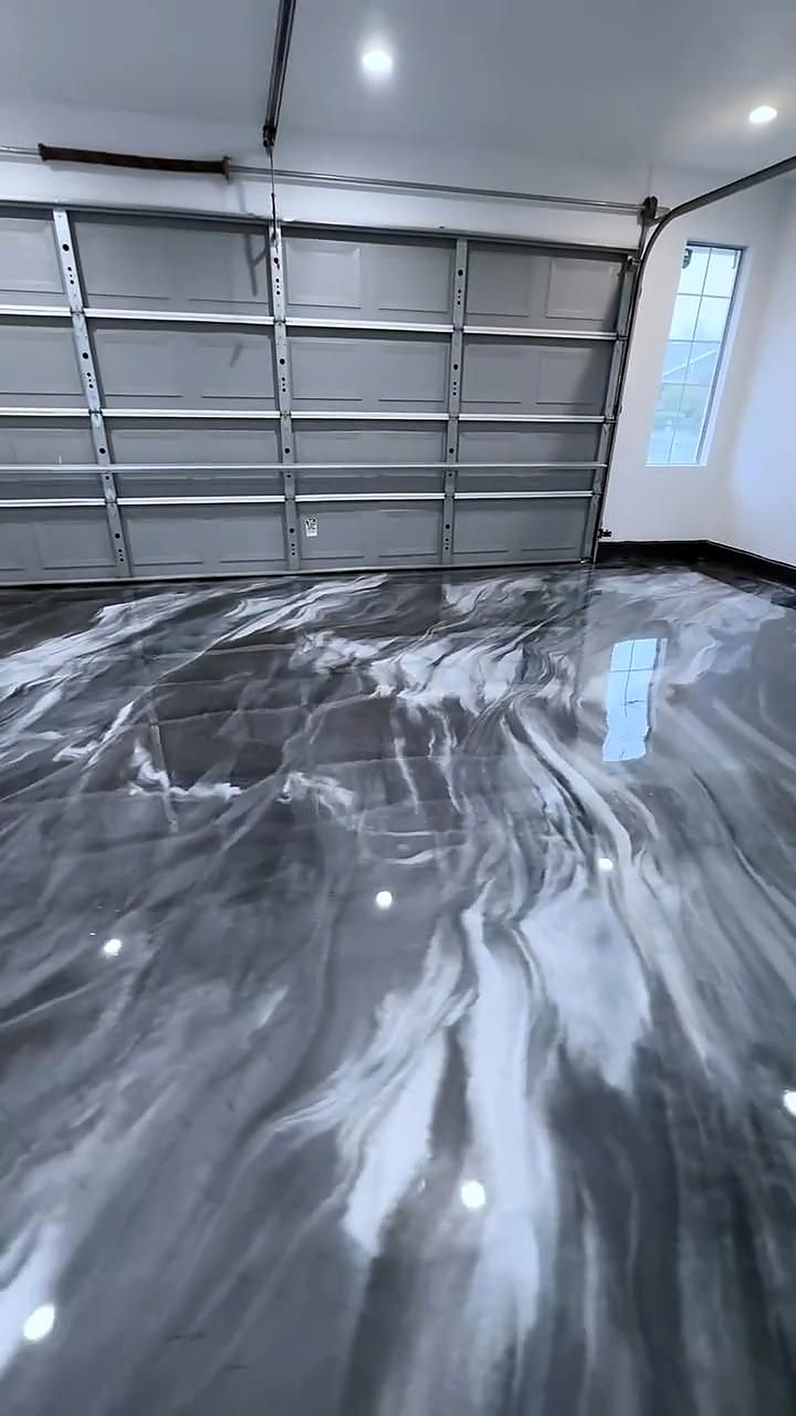 Gray and white metallic garage floor with car flags
